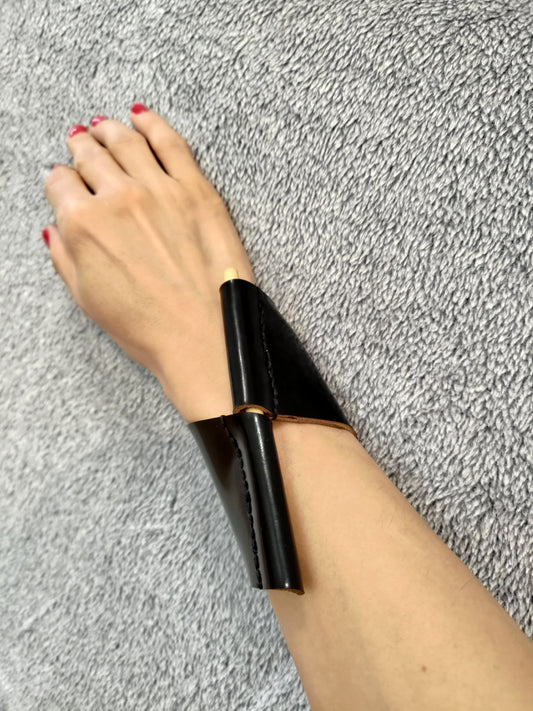 Black leather cuff with wooden pin closure