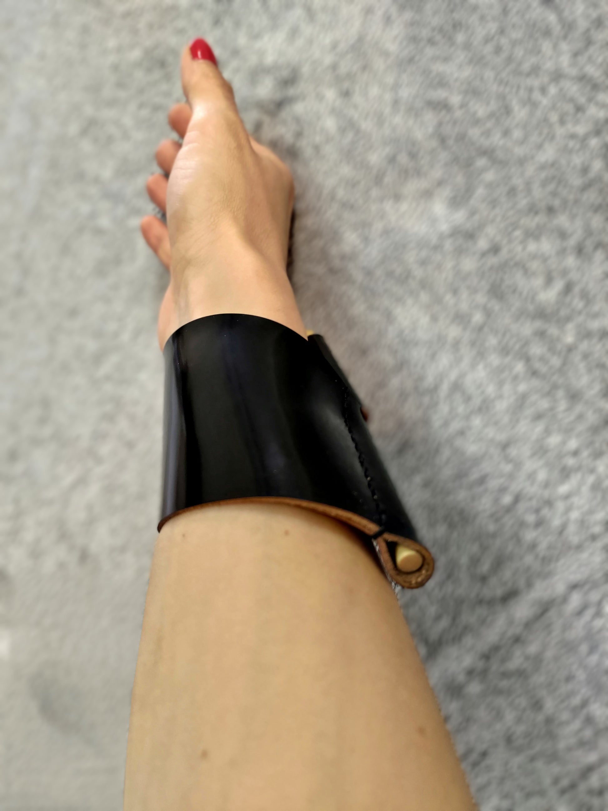 Black leather cuff with wooden pin closure