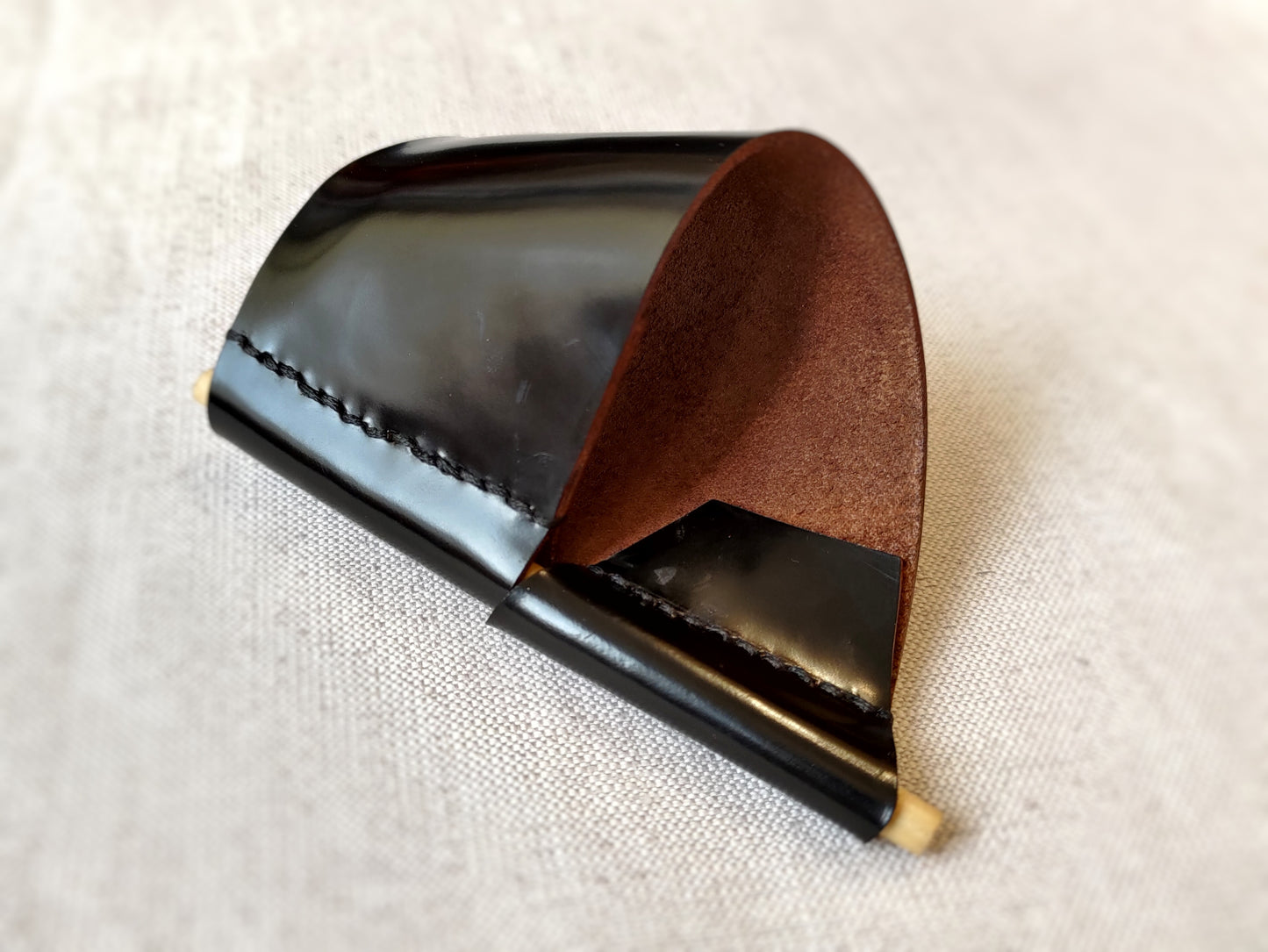 Black leather cuff with wooden pin closure