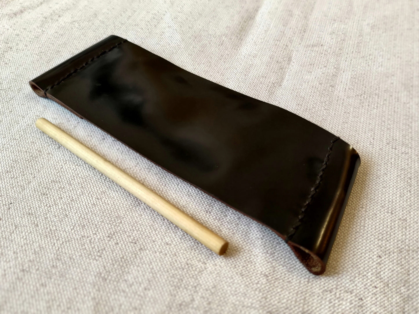 Black leather cuff with wooden pin closure