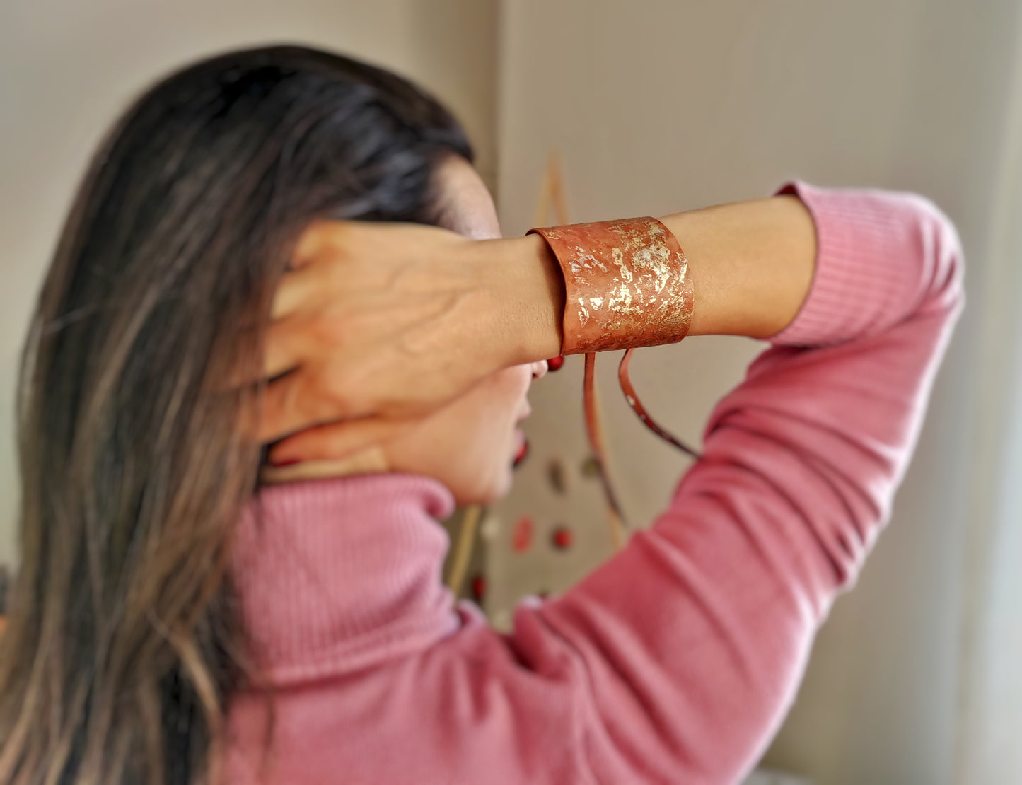 Tan leather bracelet with gold decoration